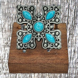 Turquoise Cross 1-1/4 inch Concho Barette - front view on wooden stand.