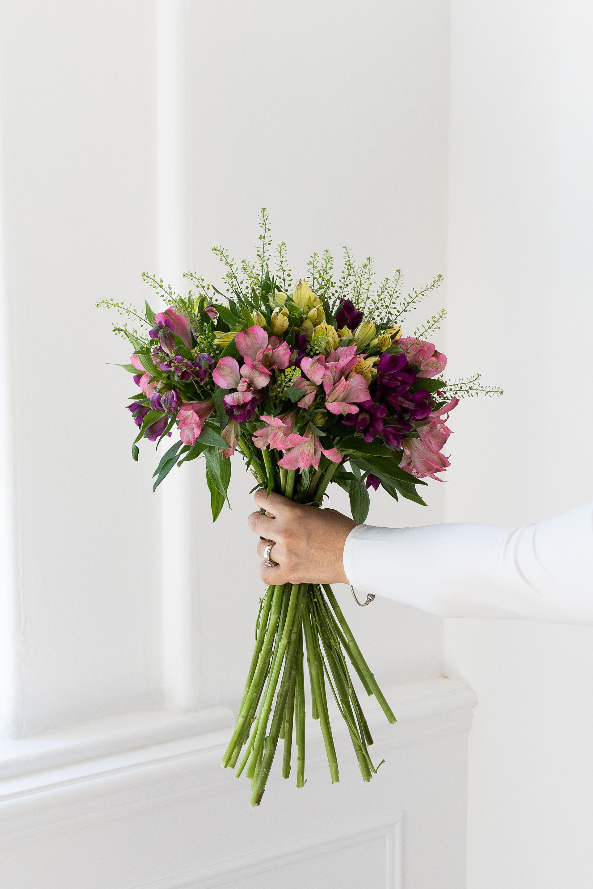 Hand-tied alstroemeria bouquet with vibrant pink and burgundy blooms.