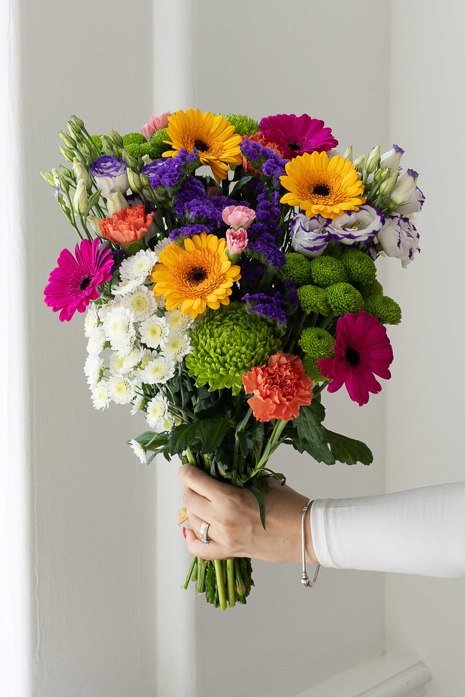 Colourful mixed bouquet with yellow and pink gerberas and green chrysanthemums.