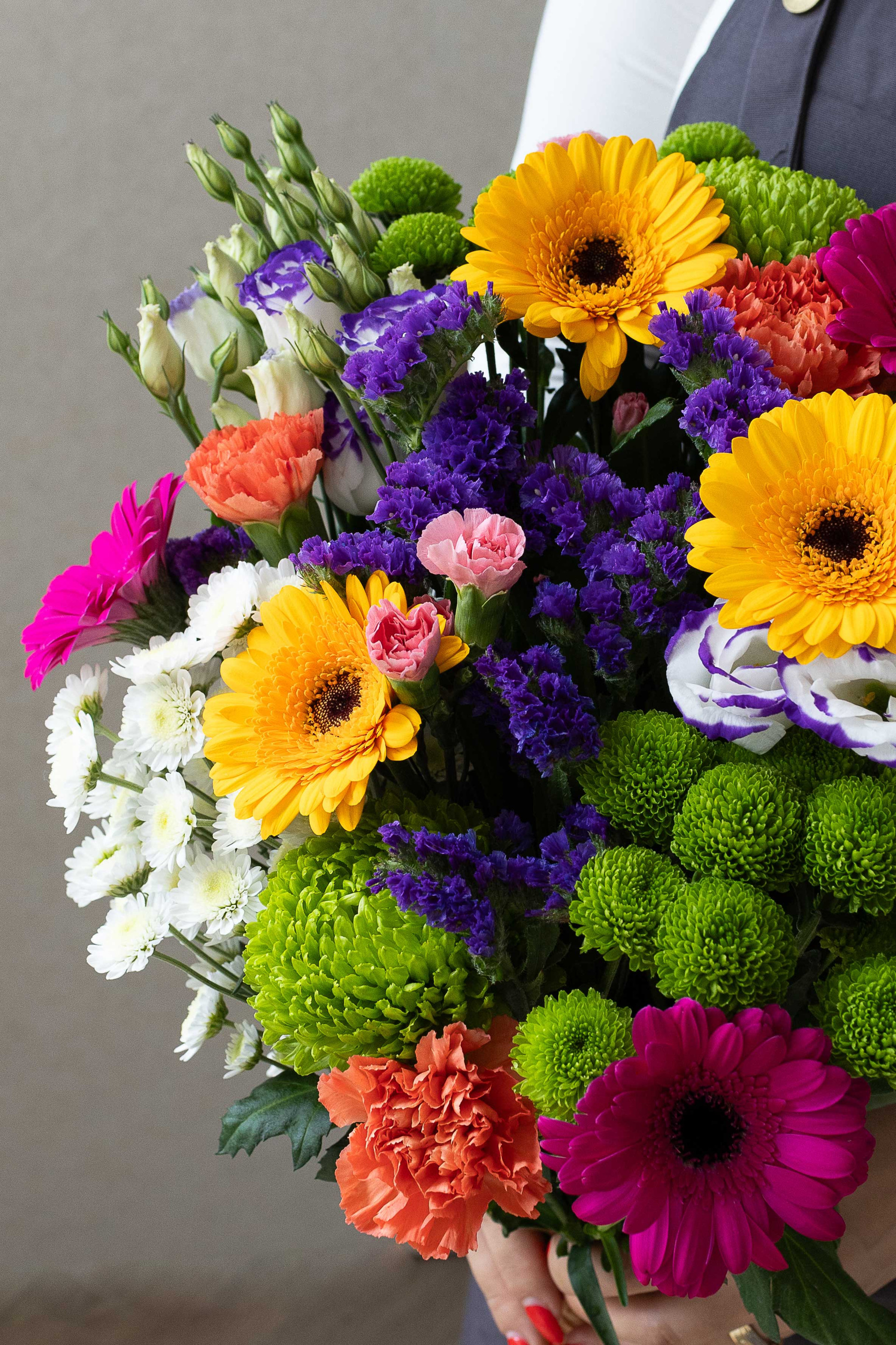 Colourful mixed bouquet with yellow and pink gerberas and green chrysanthemums.