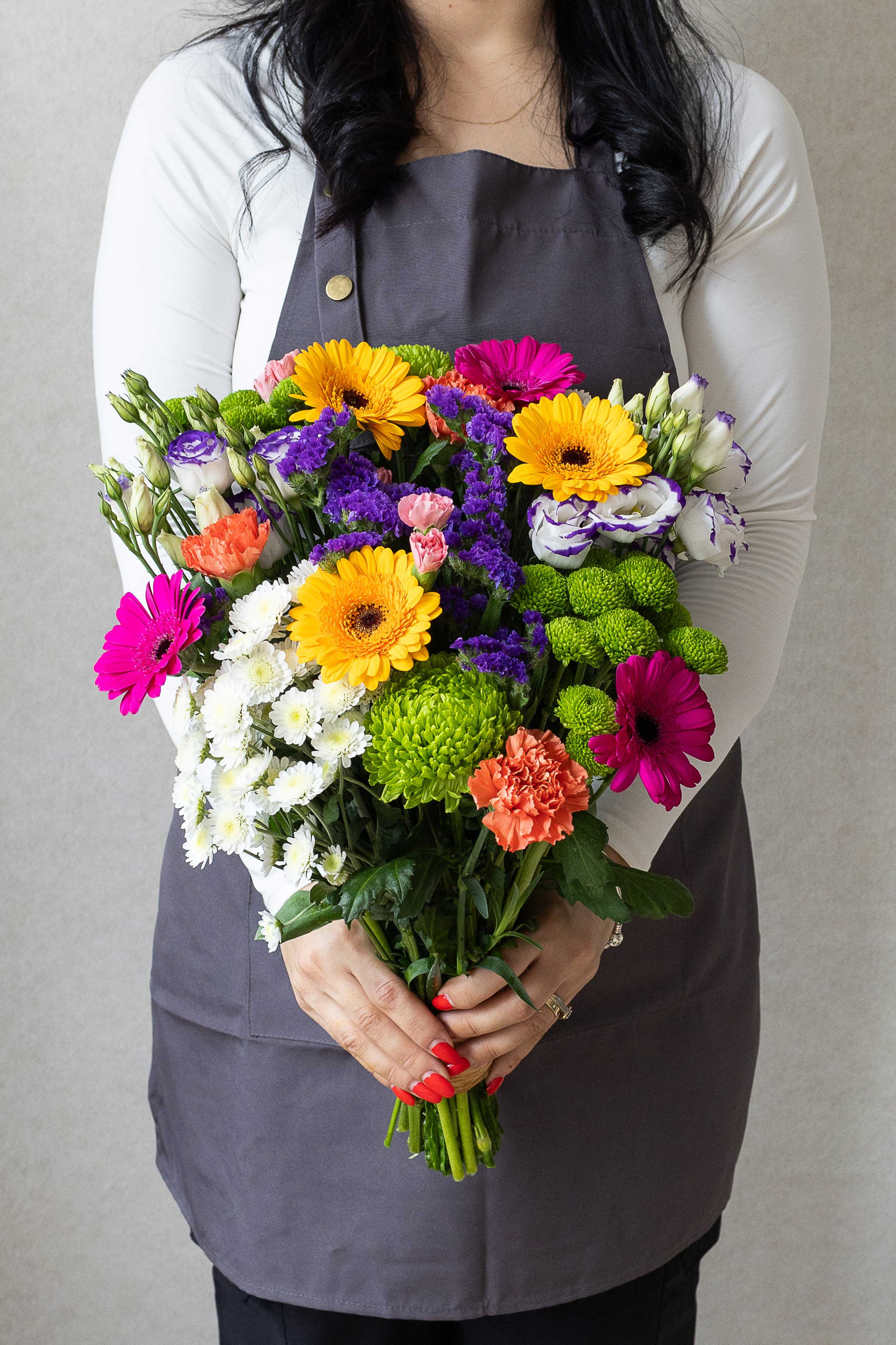Vibrant mixed flower bouquet with bright gerberas and seasonal blooms.