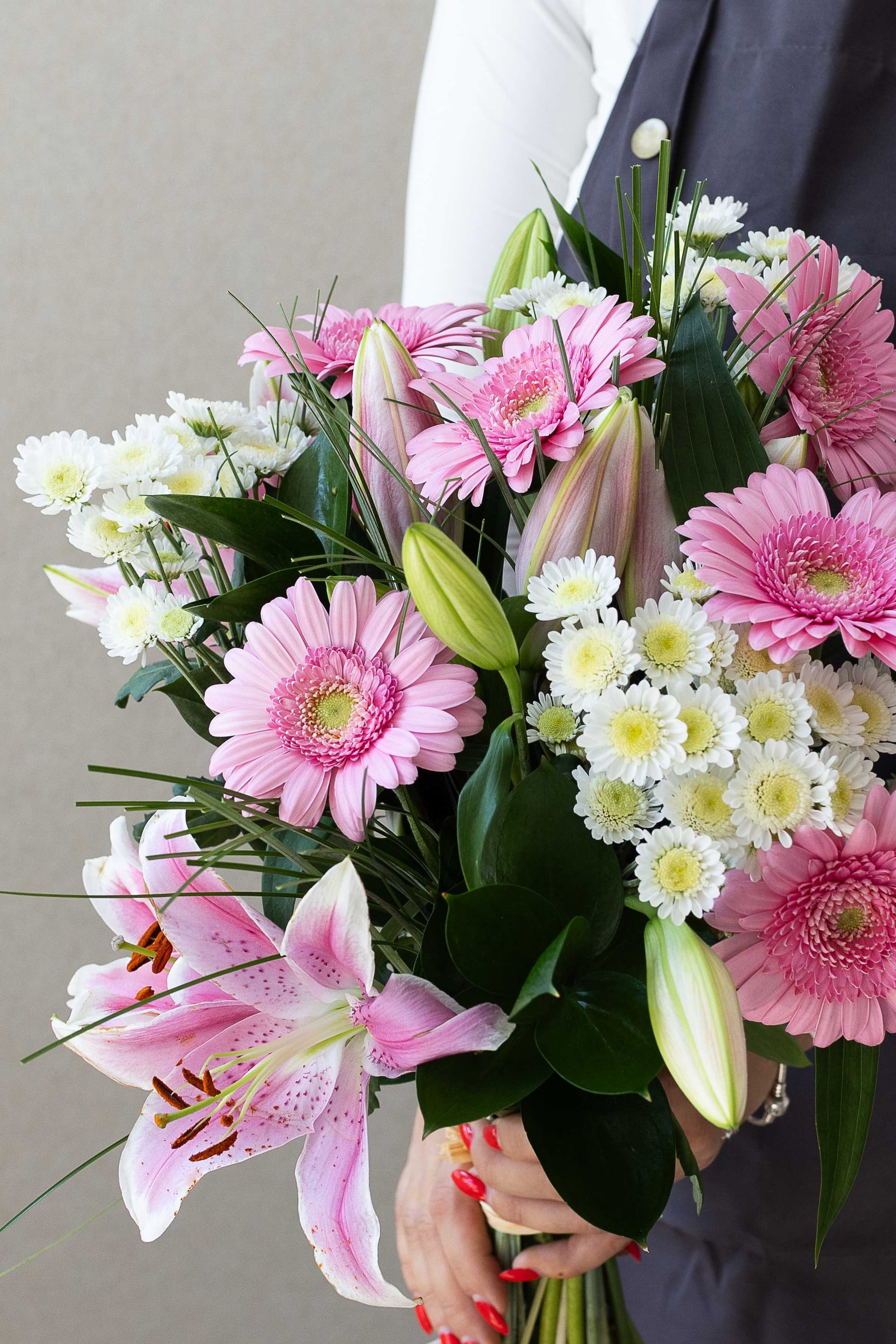 Close-up of pink lilies, pink gerberas and white chrysanthemums.