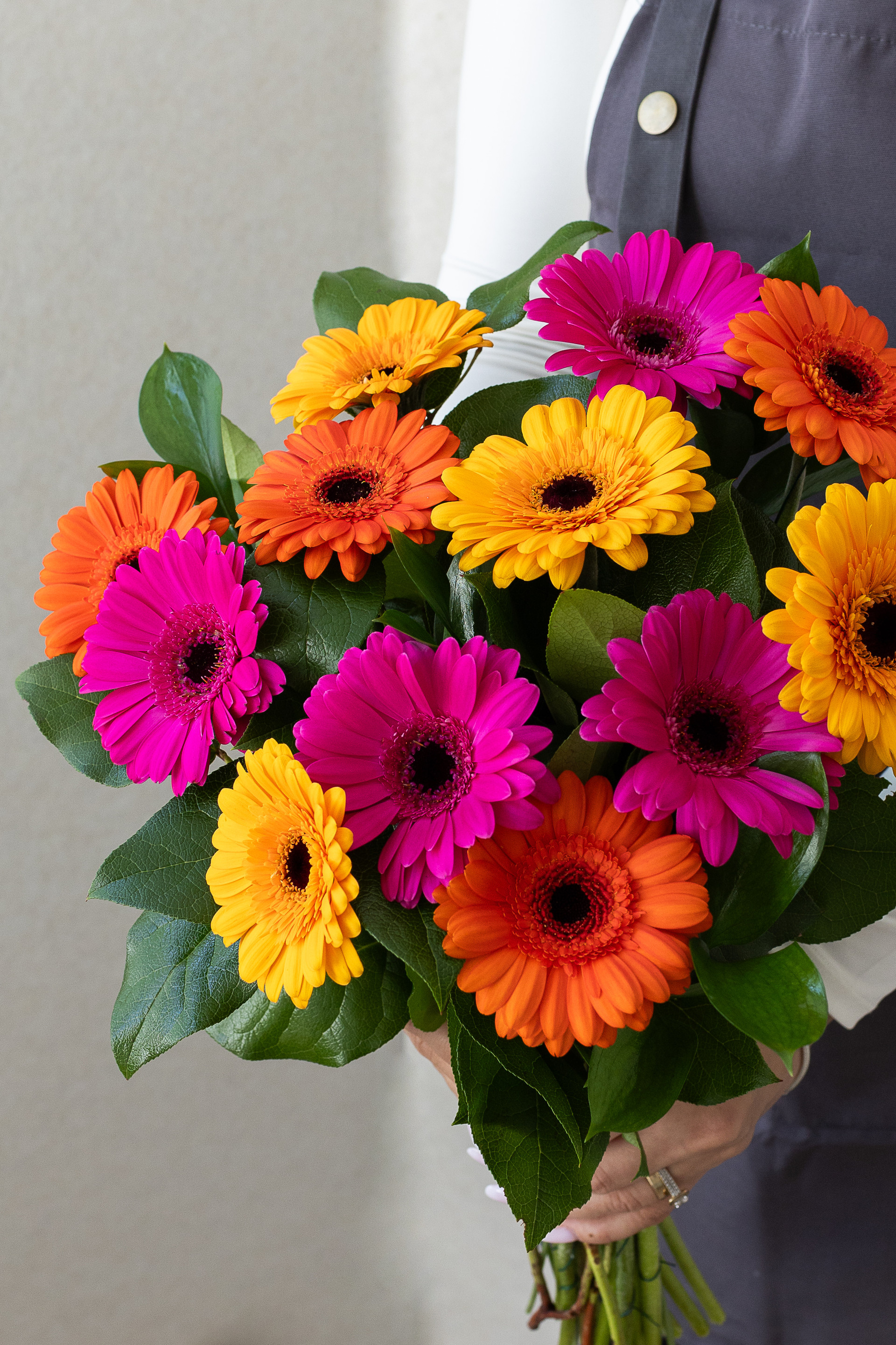 Close-up of pink, orange, and yellow gerbera daisies.