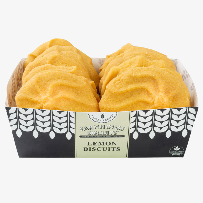 Tray of Farmhouse Biscuits Lemon Biscuits, showing golden-yellow ridged biscuits arranged in a black-and-white display tray.