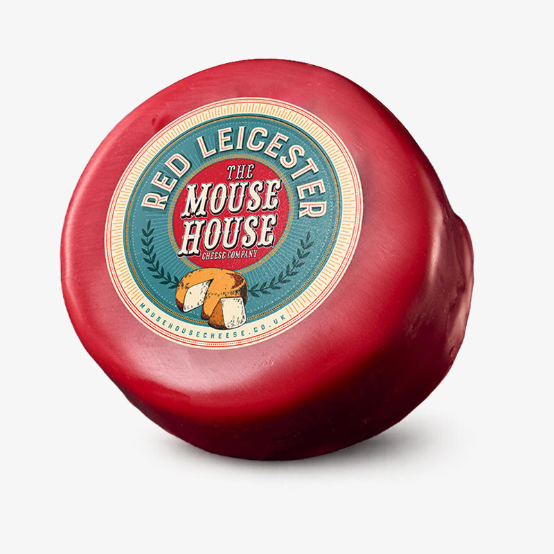 Round red wax-coated truckle of The Mouse House Red Leicester cheese.