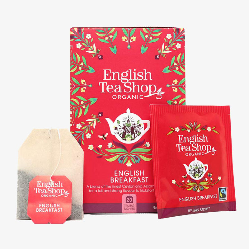 English Tea Shop Organic English Breakfast tea box with matching tea bag and individually wrapped tea sachet in bright red packaging.