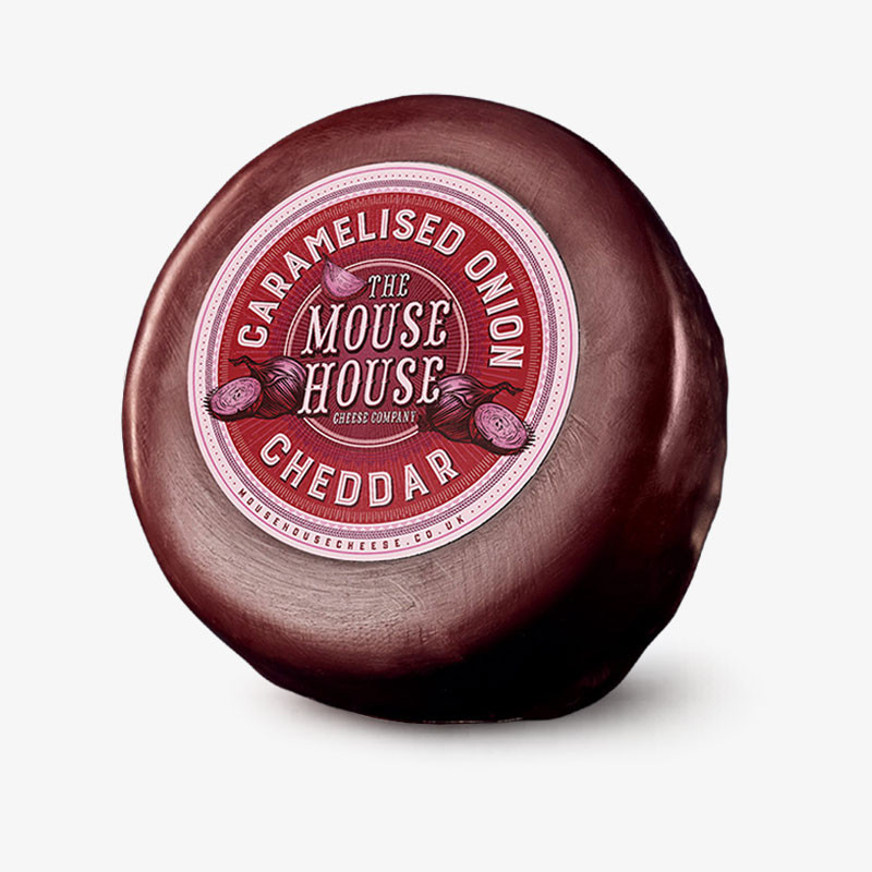 Round wax-coated truckle of The Mouse House Caramelised Onion Cheddar cheese.
