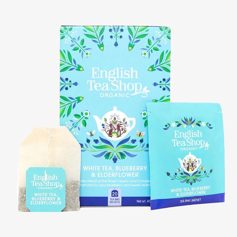 English Tea Shop Organic White Tea, Blueberry & Elderflower box with matching tea bag and individually wrapped sachet in light blue floral packaging.