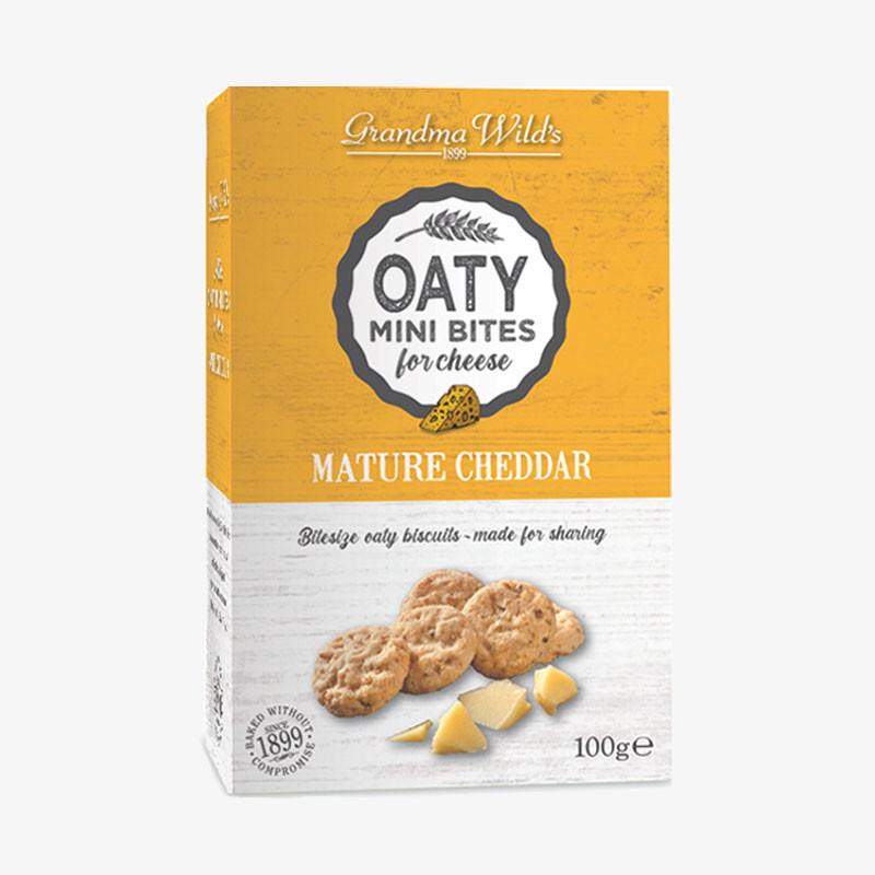 Box of Grandma Wild's Oaty Mini Bites for Cheese – Mature Cheddar, featuring oat biscuits and cheddar cheese on a yellow and white carton.