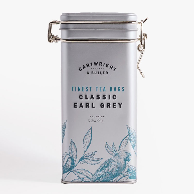 Silver clip-top tin of Cartwright & Butler Classic Earl Grey tea bags with blue botanical illustrations.