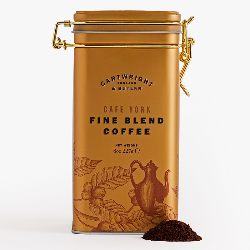 Gold clip-top tin of Cartwright & Butler Café York Fine Blend Coffee with a small pile of ground coffee displayed in front.