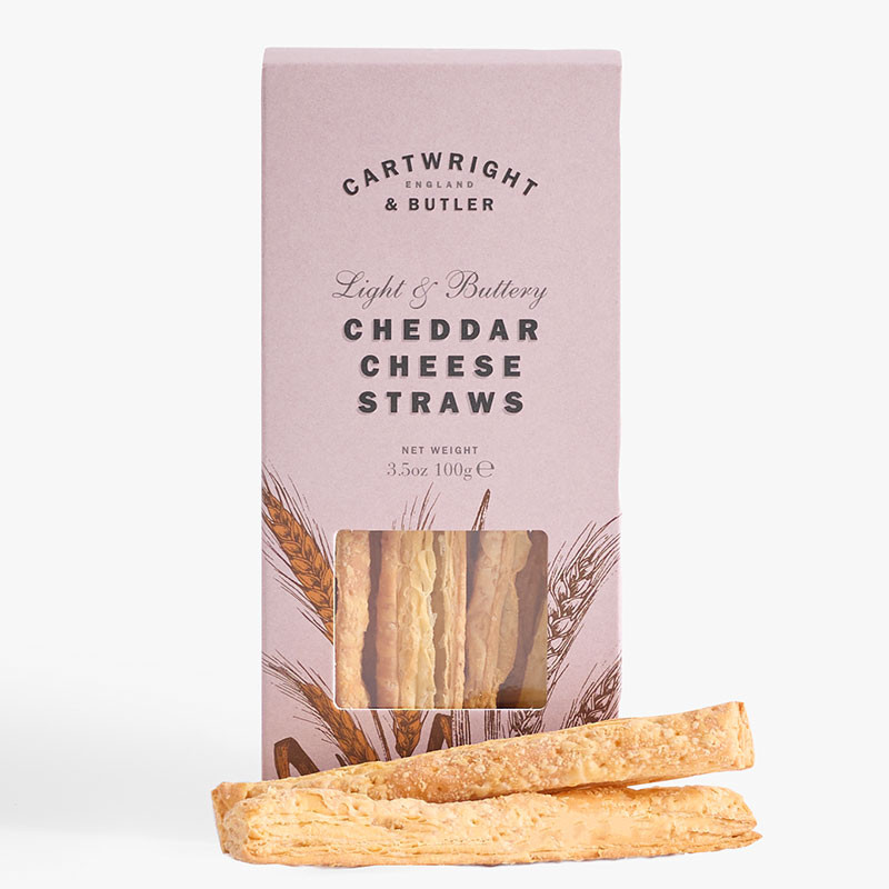 Pink box of Cartwright & Butler Cheddar Cheese Straws with cheese straws displayed in front.