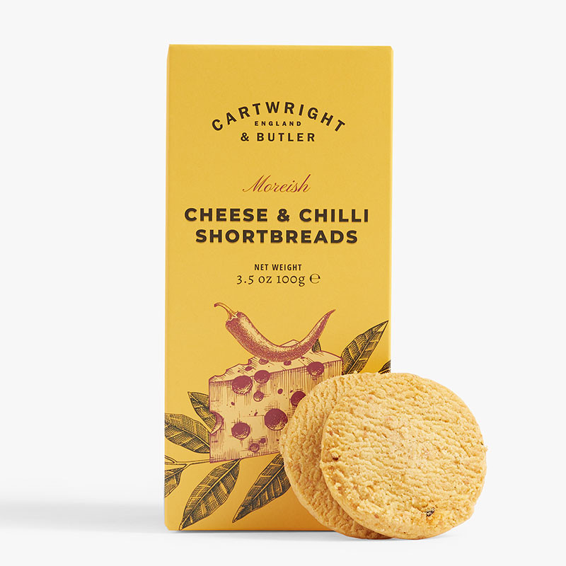 Yellow box of Cartwright & Butler Cheese & Chilli Shortbreads with two biscuits displayed in front.
