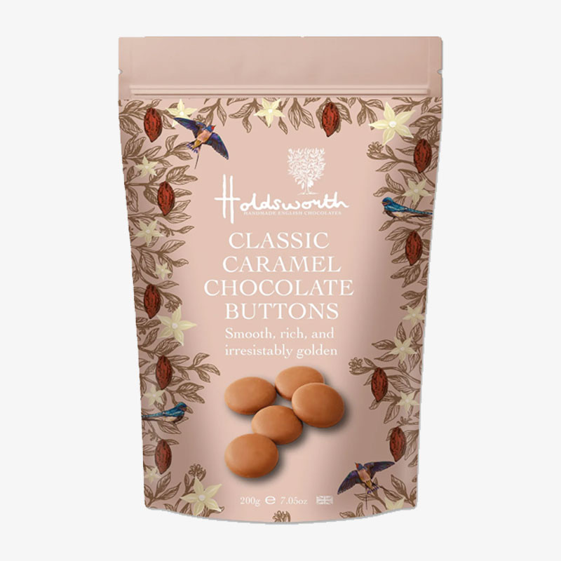 Holdsworth Classic Caramel Chocolate Buttons in a resealable caramel-pink pouch with botanical illustrations and an image of smooth caramel chocolate buttons.