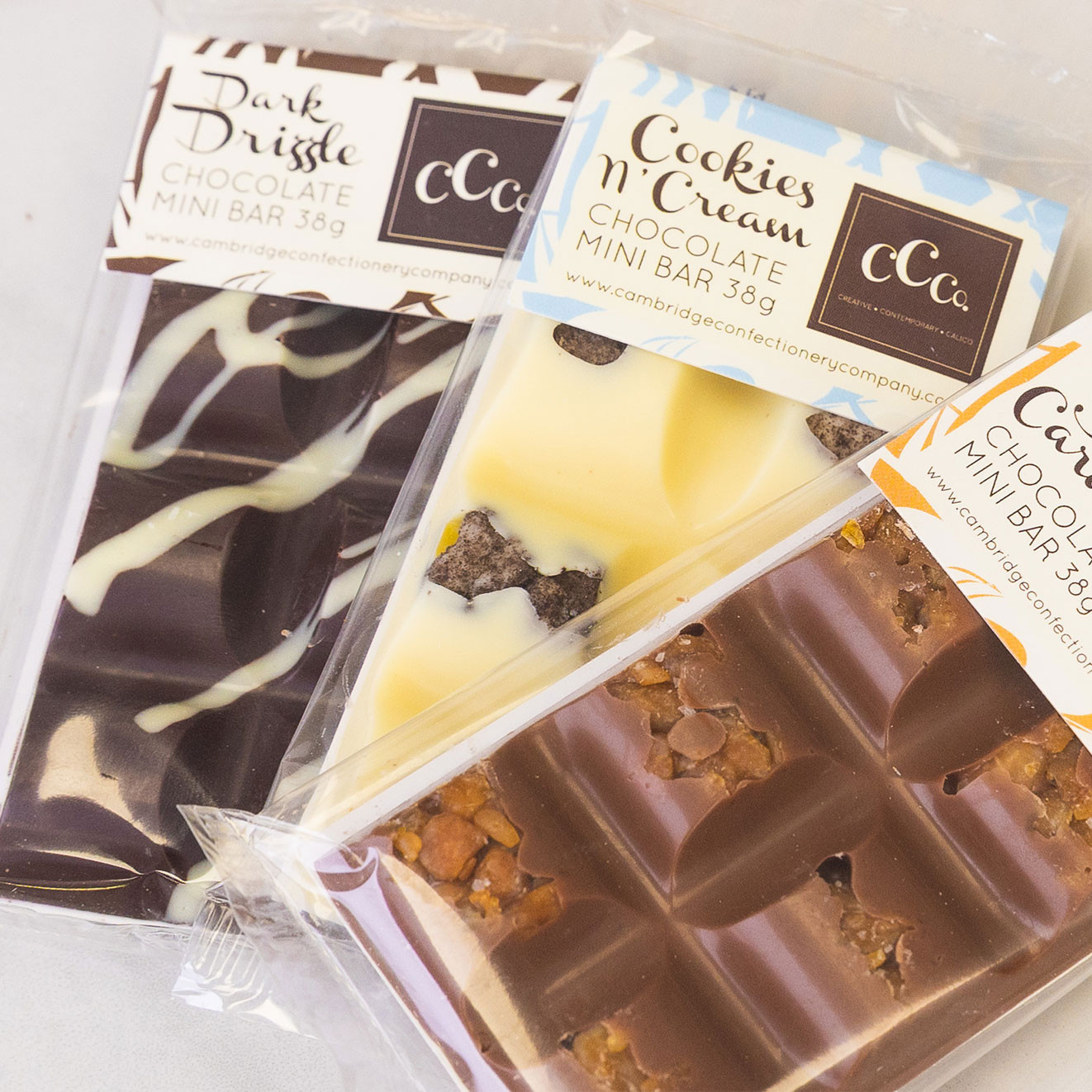 Selection of Cambridge Confectionery mini chocolate bars in Dark Drizzle, Cookies 'n' Cream and Caramel flavours.