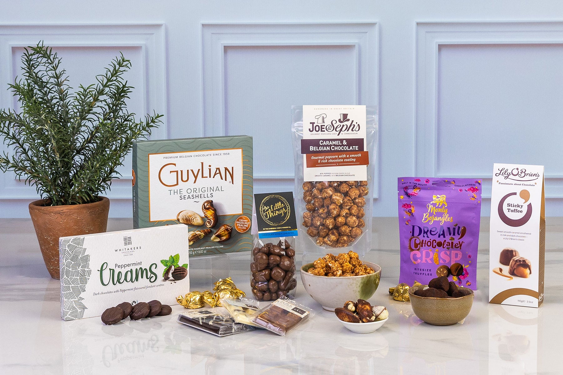 Luxury chocolate gift hamper featuring Guylian Belgian chocolates, gourmet popcorn, peppermint creams, honeycomb bites, chocolate truffles, sticky toffee chocolates and assorted chocolate bars.