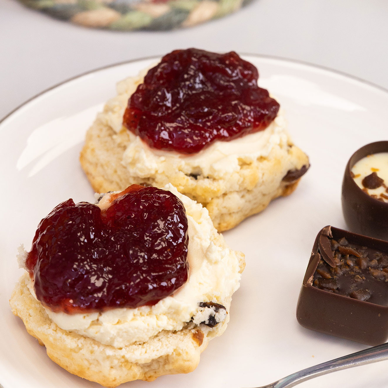 Fresh scones topped with clotted cream and strawberry jam served with assorted Butlers chocolates.