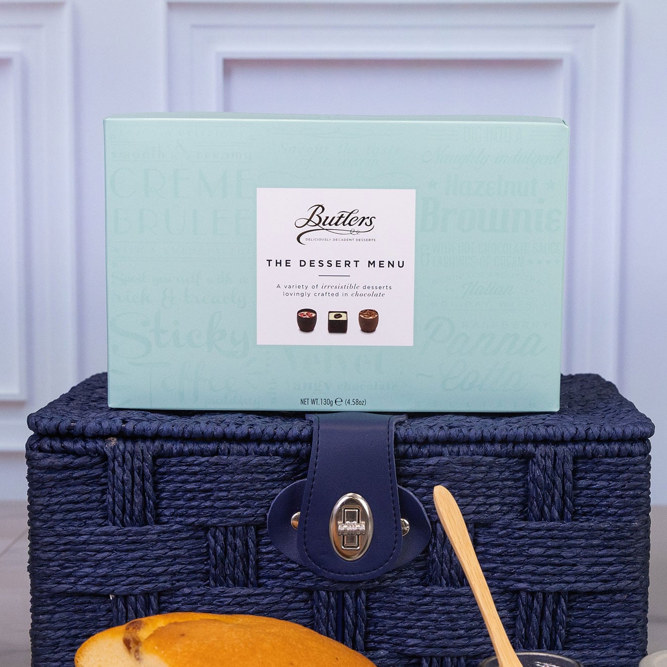 Box of Butlers The Dessert Menu assorted chocolates displayed on a navy blue picnic hamper