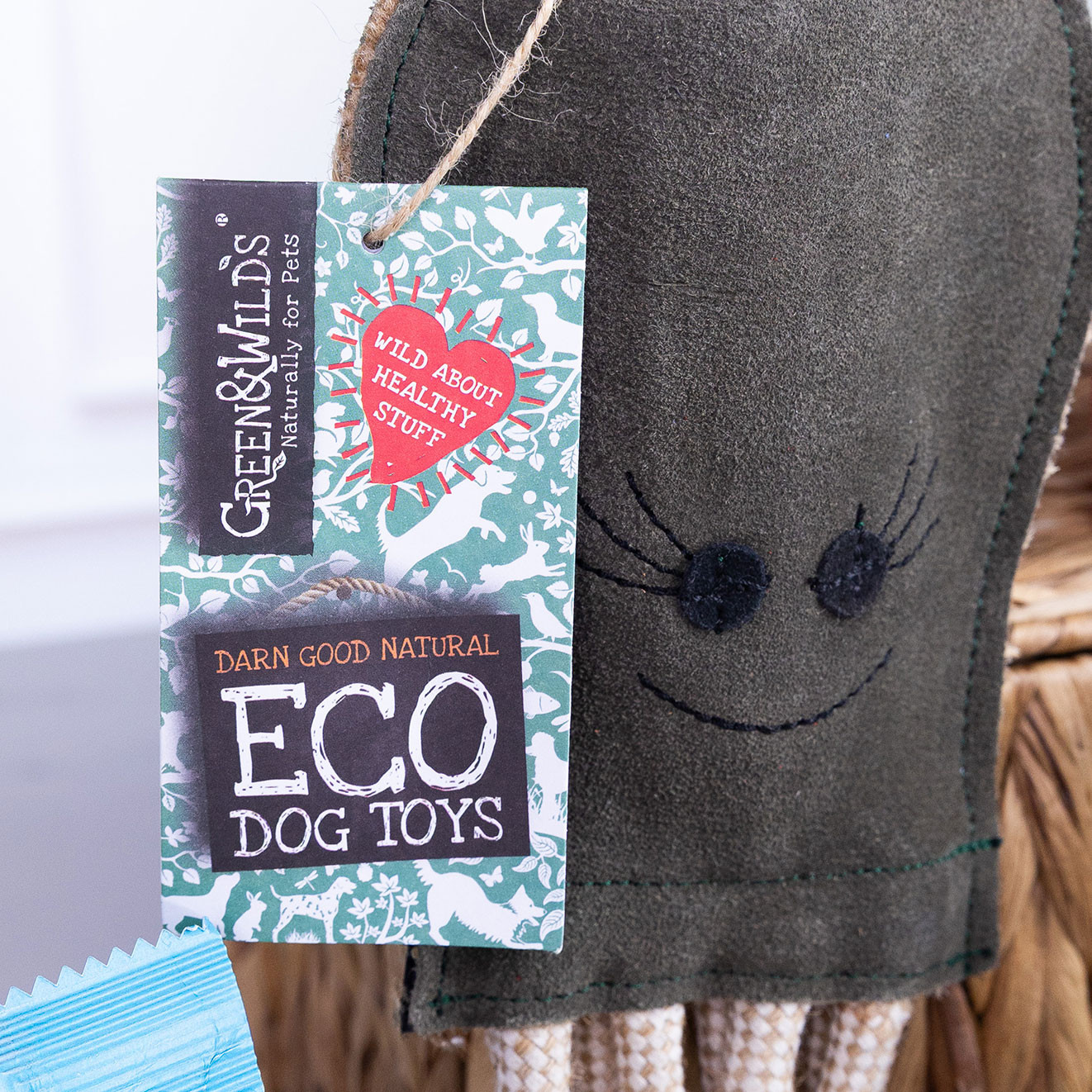 Close-up of Green & Wild's octopus-shaped eco dog toy with product tag attached.