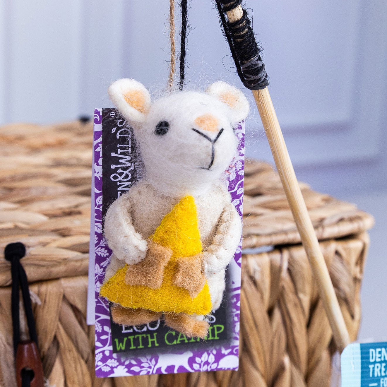 Green & Wild's felt mouse eco cat toy with catnip displayed beside a natural teaser wand.