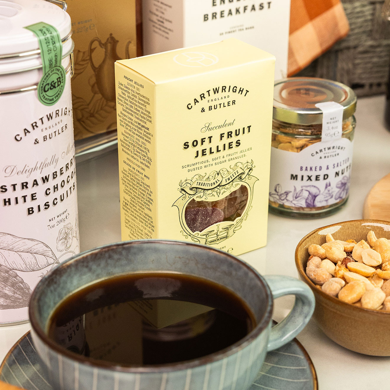 Box of Cartwright & Butler Soft Fruit Jellies displayed alongside coffee, mixed nuts and biscuits.