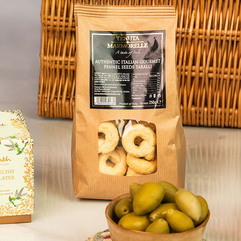 Tenuta Marmorelle Authentic Italian Gourmet Fennel Seeds Taralli displayed beside a bowl of Sicilian green olives.
