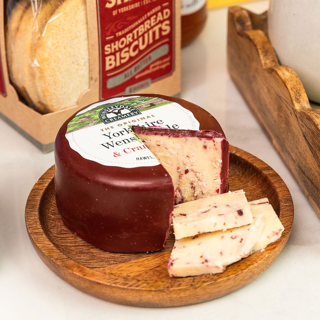Yorkshire Wensleydale & Cranberries cheese wheel with slices, perfect for serving on a cheeseboard.