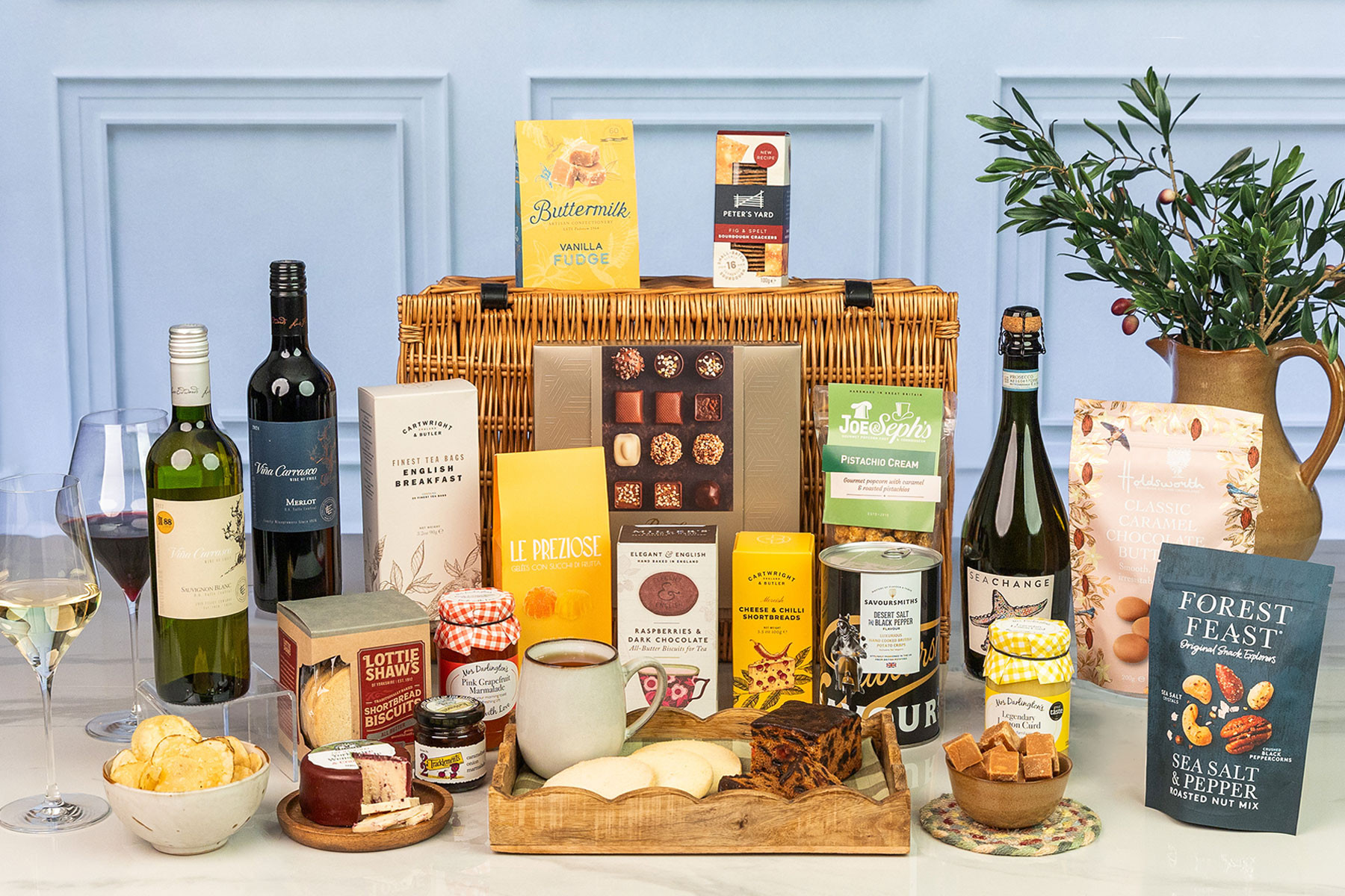 Luxury wicker hamper filled with premium wines, Prosecco, artisan chocolates, biscuits, preserves, gourmet snacks, cheese, tea and sweet treats.