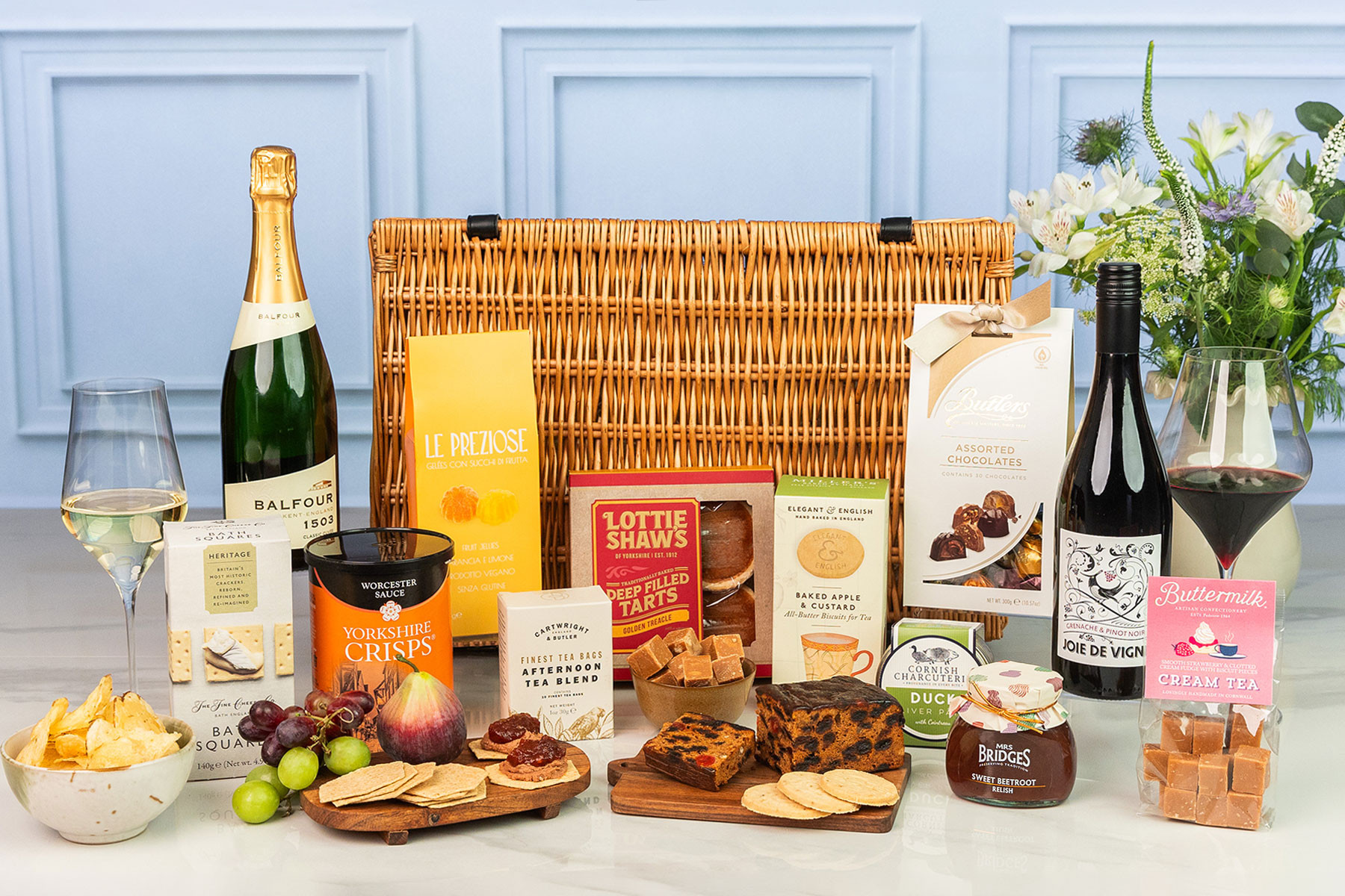 Luxury wicker hamper with English sparkling wine, red wine, artisan sweet and savoury treats, chocolates, preserves and premium picnic favourites.
