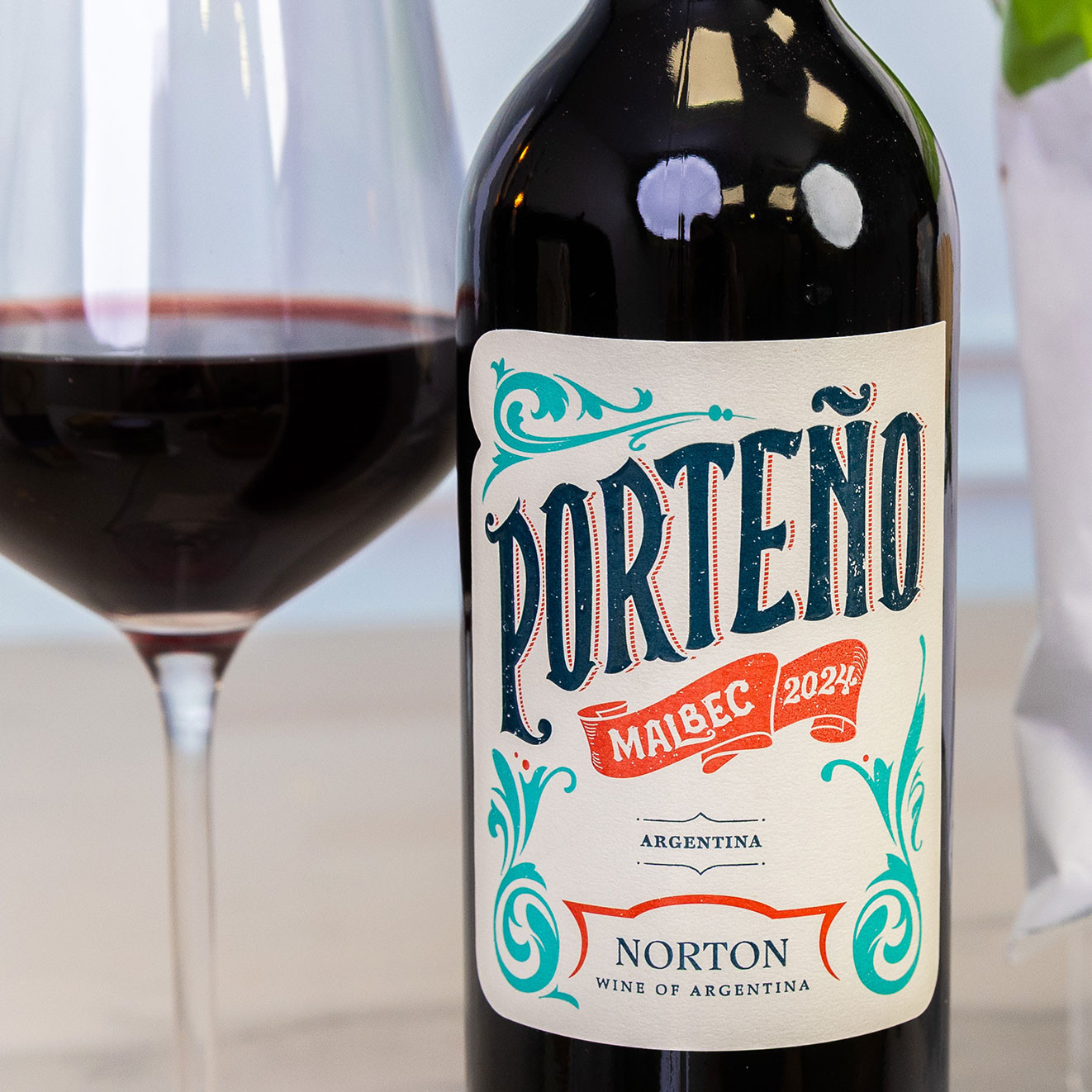 Bottle of Norteño Malbec 2024 from Argentina displayed beside a glass of red wine, ideal for pairing with charcuterie and cheese.