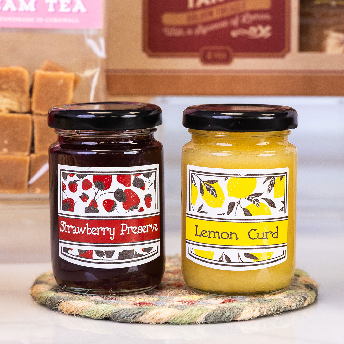 Mini jars of strawberry preserve and lemon curd, ideal accompaniments for scones, pastries and afternoon tea.