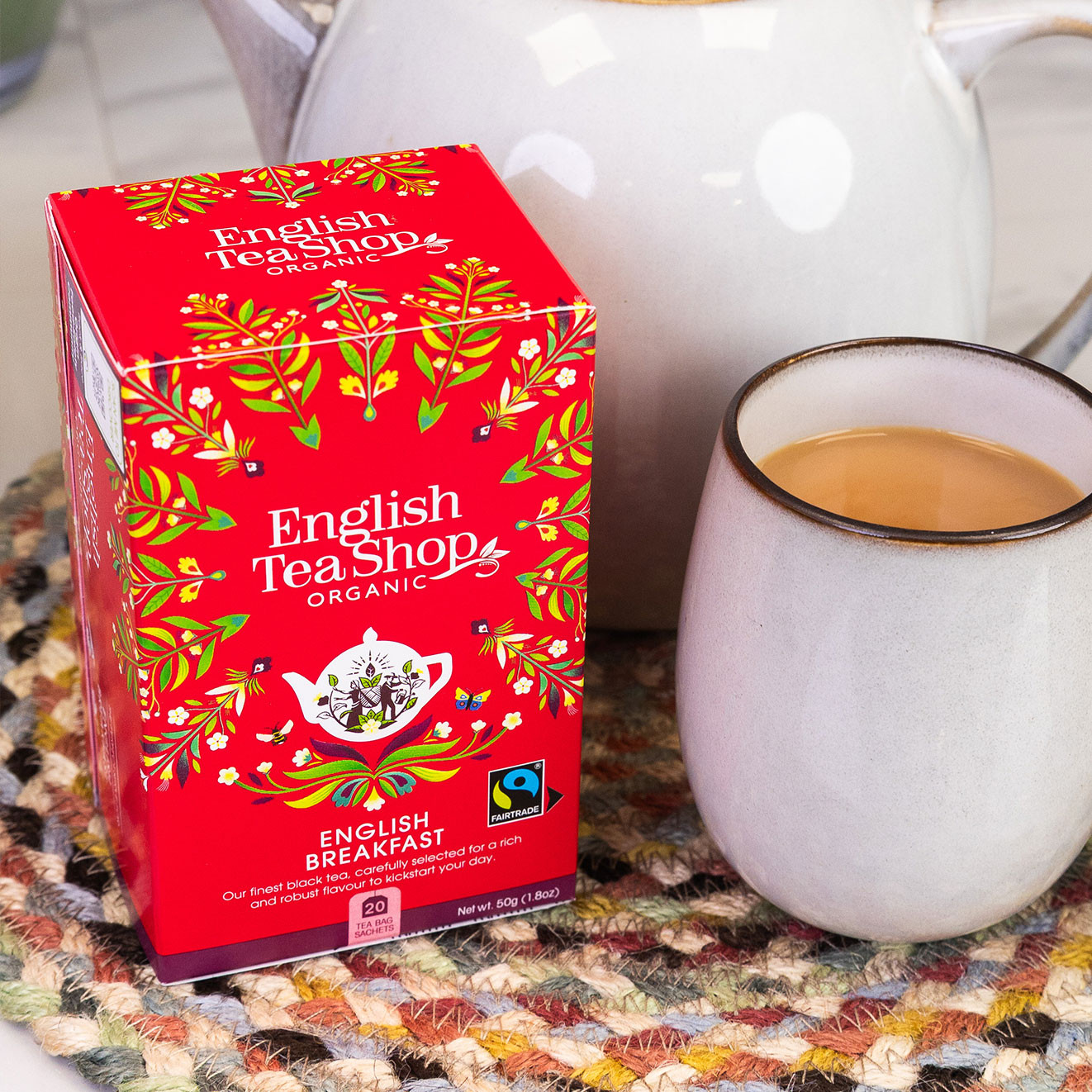 English Tea Shop Organic English Breakfast tea beside a freshly brewed mug of tea and teapot, perfect for a traditional afternoon tea.