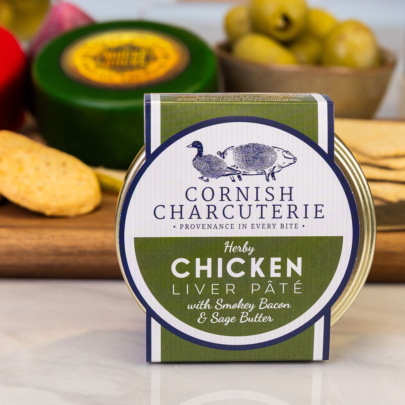 Cornish Charcuterie Herby Chicken Liver Pâté with Smokey Bacon and Sage Butter, ideal for serving with crackers and cheese.