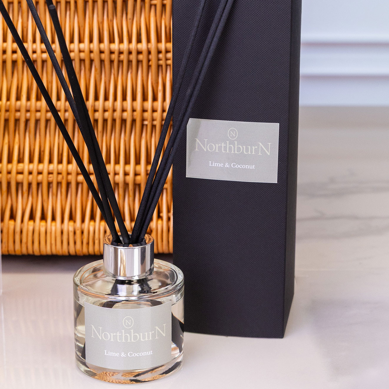 NorthburN Lime & Coconut reed diffuser with elegant glass bottle, black reeds and matching gift box.