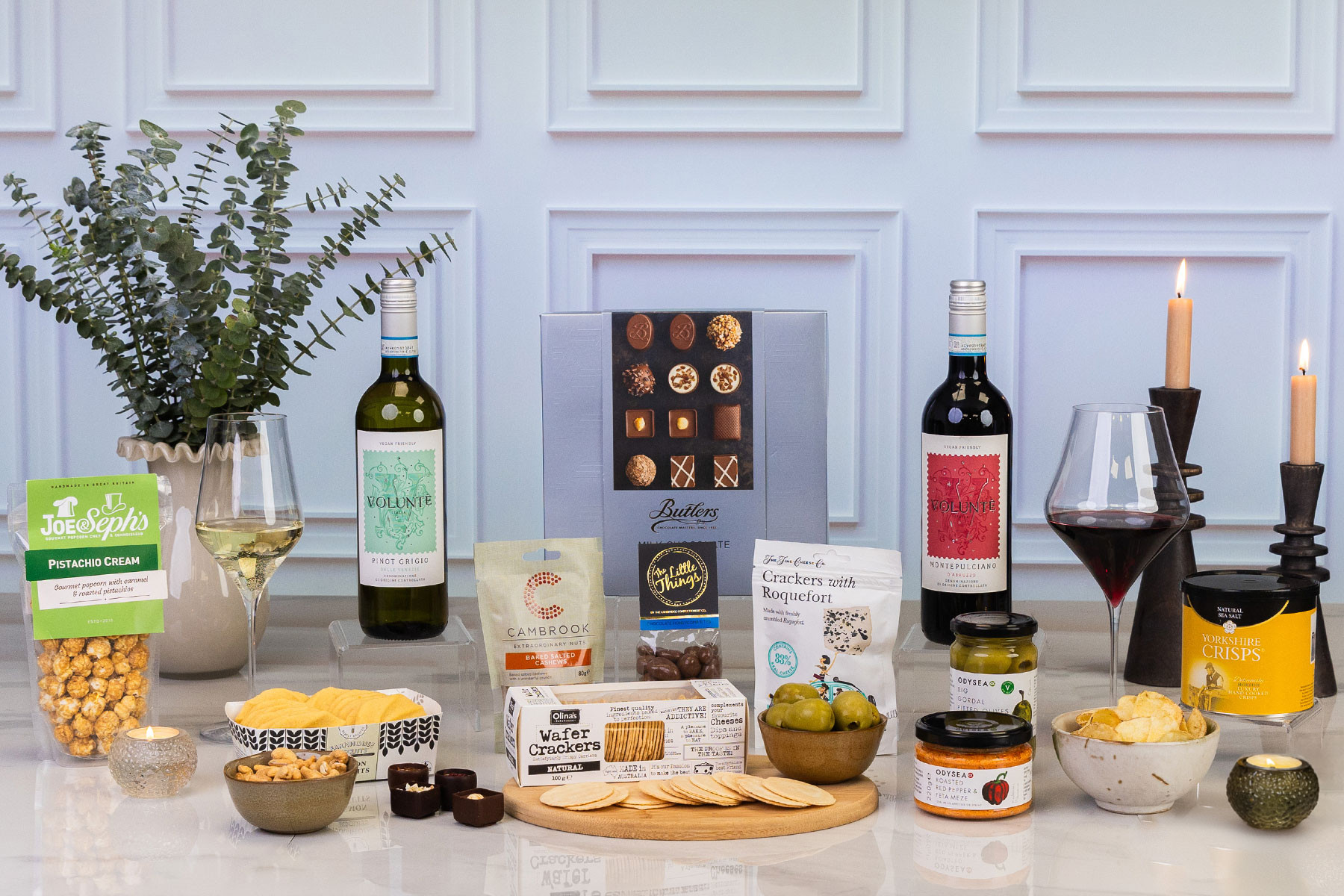 Luxury wine and savoury gift hamper featuring red and white wine, artisan chocolates, gourmet snacks, olives, crackers, crisps and premium antipasti.