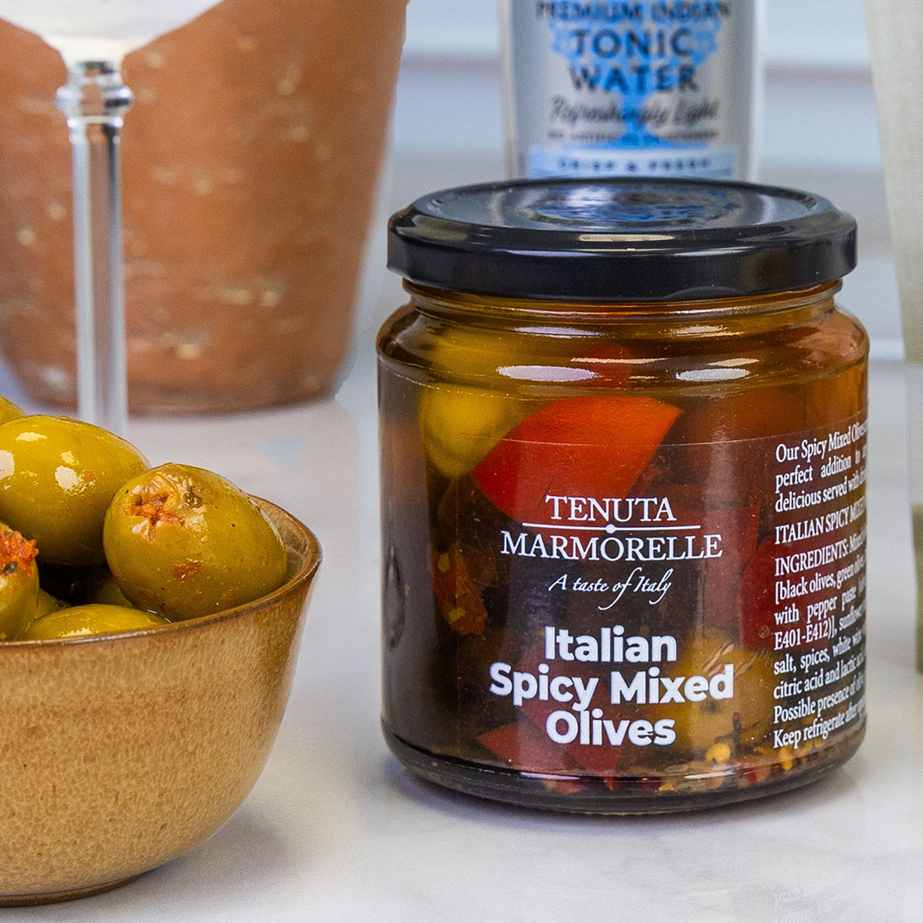 Tenuta Marmorelle Italian Spicy Mixed Olives marinated with herbs and peppers, ideal for cocktail hour and antipasti platters.