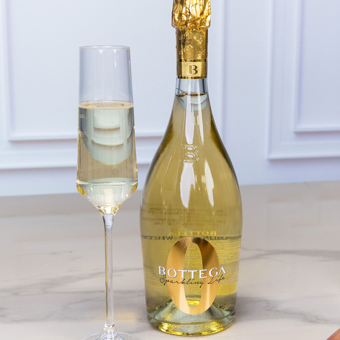 Bottle of Bottega Sparkling Life sparkling wine served alongside a filled champagne flute, perfect for celebrations and gifting.