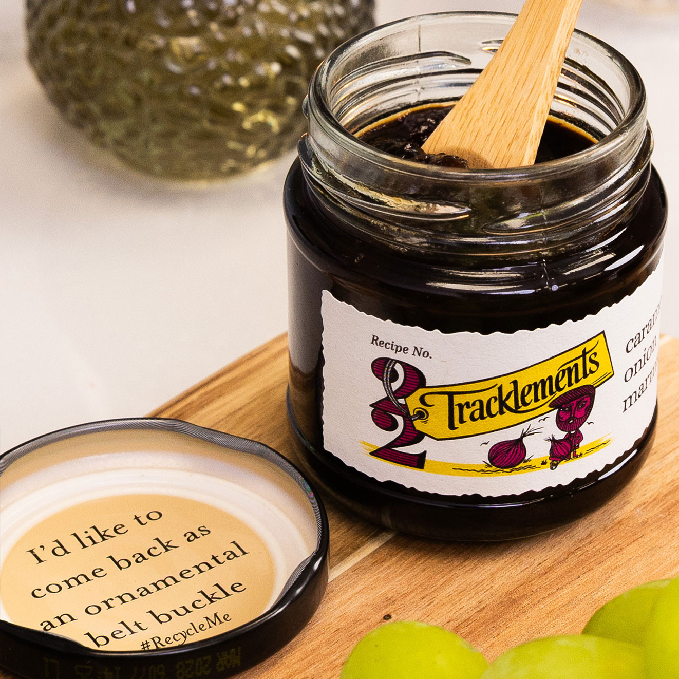Tracklements Caramelised Onion Marmalade in an open jar with serving spoon, ideal for complementing cheese and crackers.