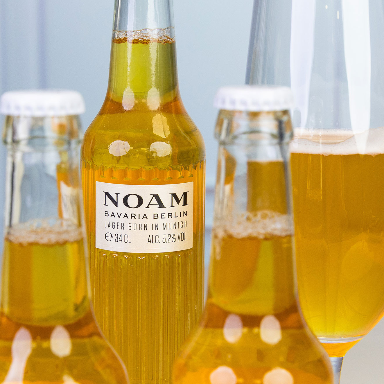 NOAM Bavarian Berlin lager bottles served alongside a poured glass of crisp golden beer for a premium drinks hamper.