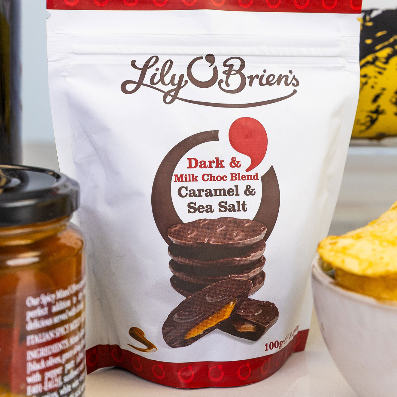 Lily O'Brien's dark and milk chocolate blend discs with caramel and sea salt, presented in a resealable sharing pouch.