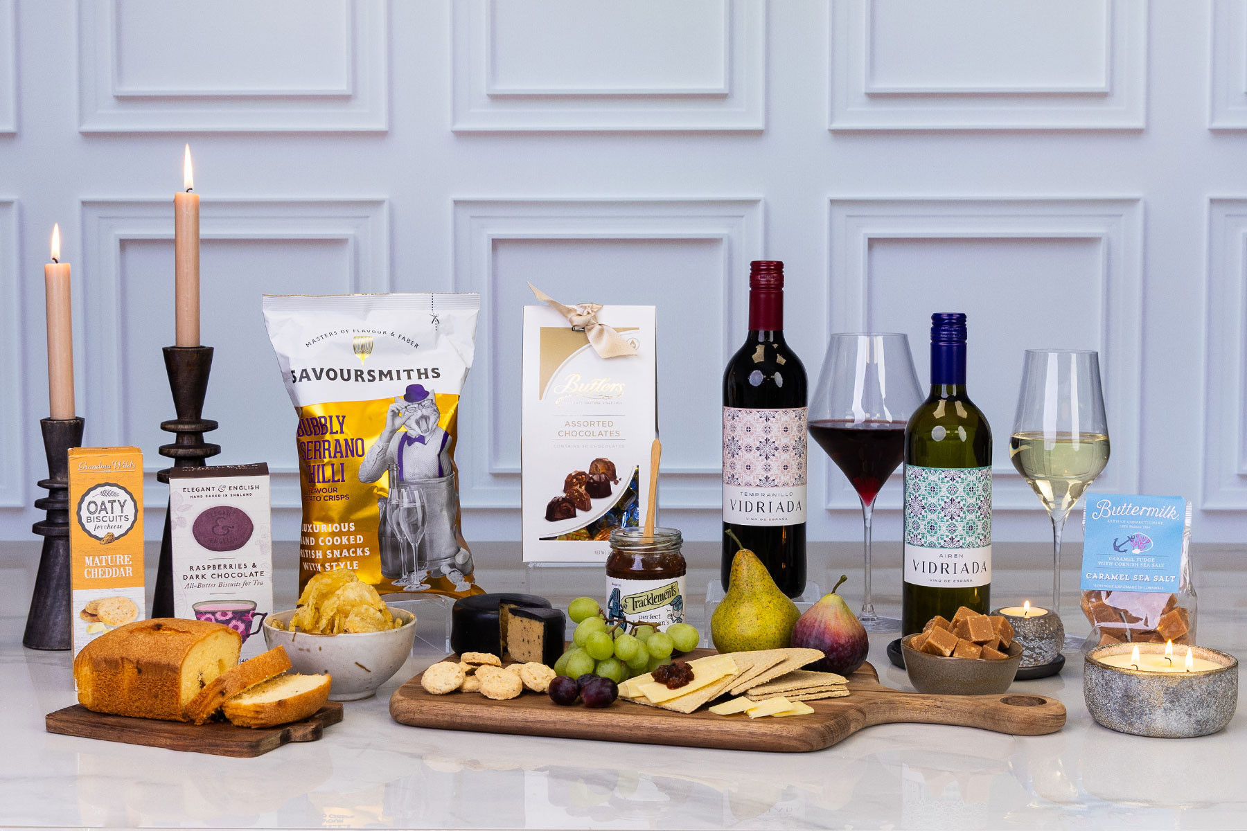 Luxury wine and gourmet food hamper featuring Spanish red and white wines, artisan chocolates, savoury snacks, cheese, crackers, chutney, fudge and fruit.