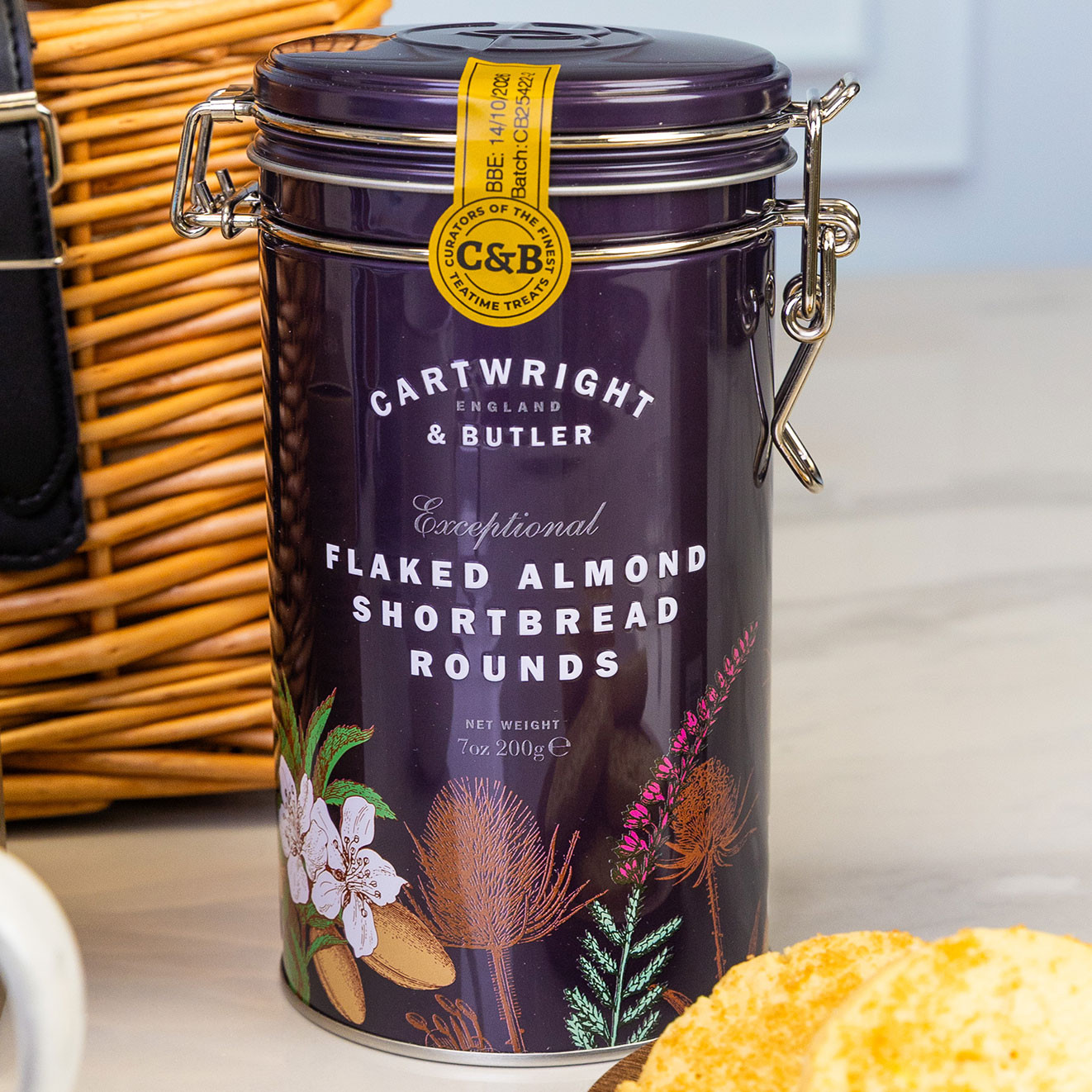 Cartwright & Butler flaked almond shortbread rounds in a decorative storage tin, ideal for serving with tea or coffee.
