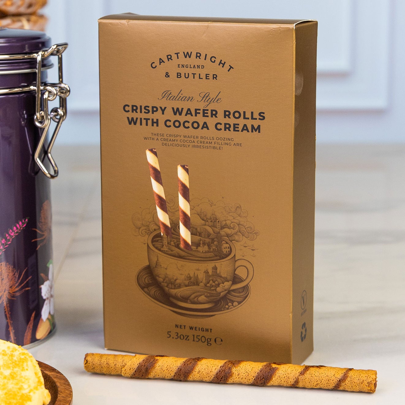 Cartwright & Butler crispy wafer rolls filled with rich cocoa cream, served alongside a single wafer for an indulgent sweet treat.