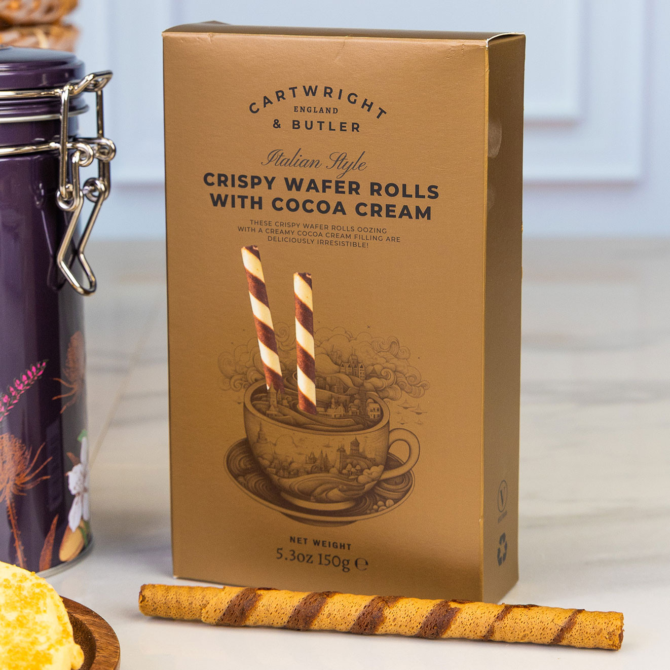 Cartwright & Butler crispy wafer rolls filled with rich cocoa cream, served alongside a single wafer for an indulgent sweet treat.