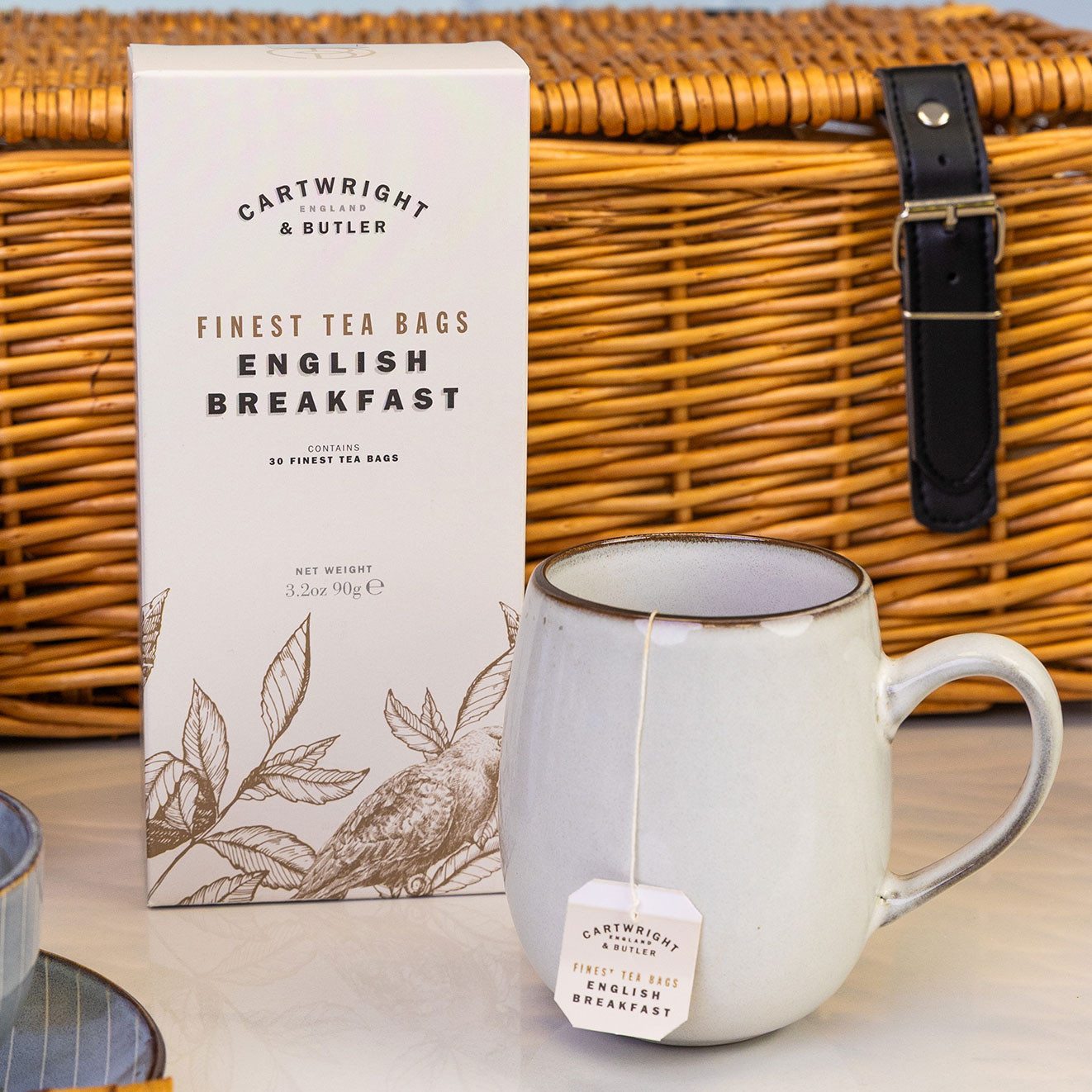 Cartwright & Butler English Breakfast tea bags presented with a ceramic mug and tea bag, ready for a comforting morning brew.
