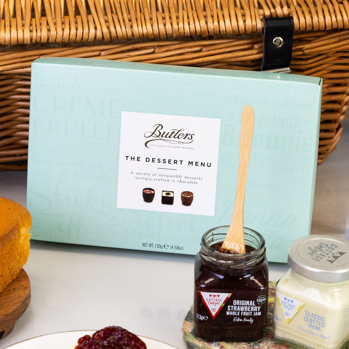 Butler's Dessert Menu luxury chocolate selection presented with strawberry jam and classic clotted cream, perfect for pairing with fresh scones.