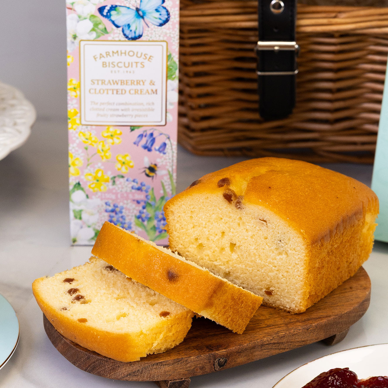 Traditional fruit loaf with sliced pieces on a wooden serving board, ideal for serving with butter and afternoon tea.