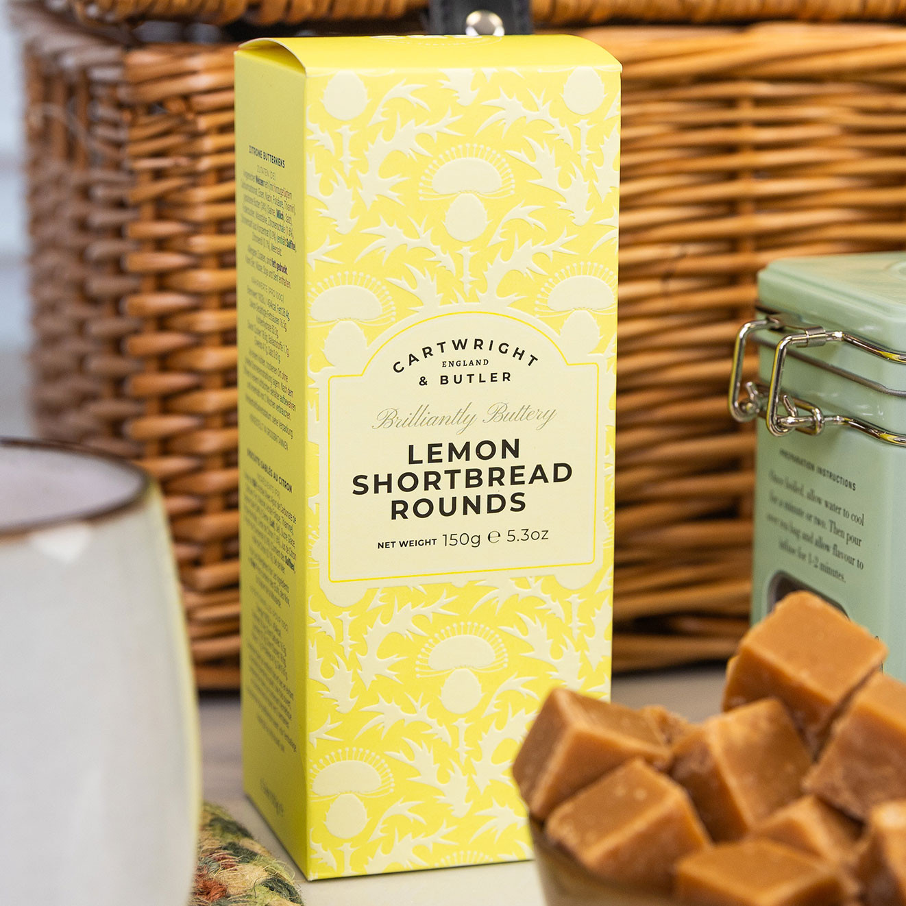 Cartwright & Butler Lemon Shortbread Rounds in a decorative gift box, accompanied by creamy fudge cubes for an indulgent sweet pairing.