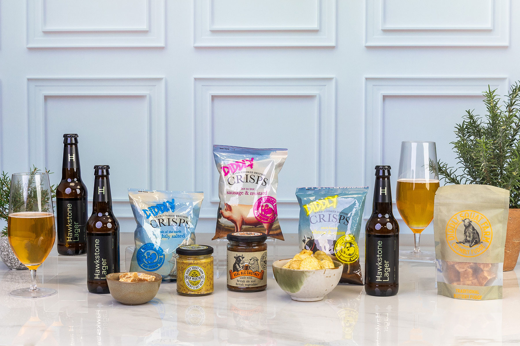 Beer and savoury gift hamper featuring Hawkstone Lager, gourmet British crisps, beer mustard, ale chutney, traditional fudge and pub-style snacks, presented for sharing and entertaining.