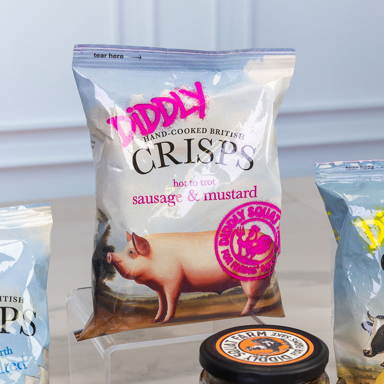 Bag of Diddly Hand-Cooked British Crisps in Hot to Trot Sausage & Mustard flavour, offering a bold and savoury pub-inspired snack.
